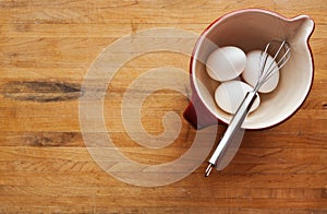 Bowl filled with eggs and whisk