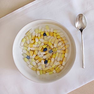 A bowl filled with medicine pills