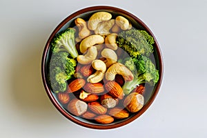 Bowl Filled With Nuts and Broccoli on Table