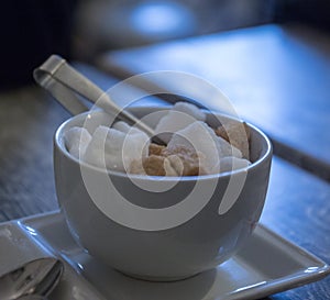 A bowl filled with sugar cubes at a coffee shop