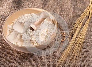 Bowl with flour and ears of wheat