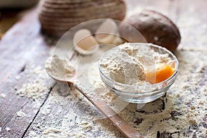 Bowl of flour with egg and bread