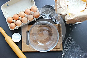 A bowl of flour and egg on the kitchen table