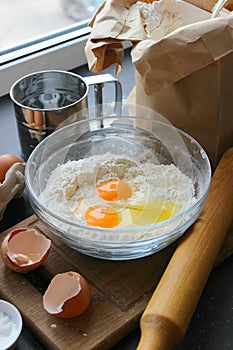 A bowl of flour and egg on the kitchen table