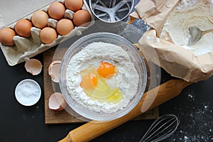 A bowl of flour and egg on the kitchen table