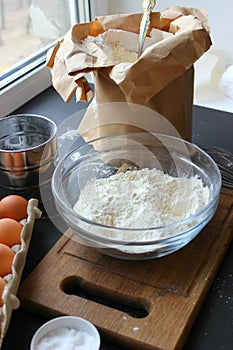 A bowl of flour and egg on the kitchen table