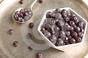 Bowl with fresh acai berries on tray,