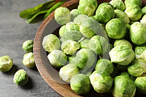 Bowl of fresh Brussels sprouts on grey table