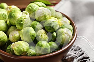 Bowl of fresh Brussels sprouts on table