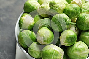 Bowl of fresh Brussels sprouts on table