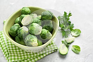 Bowl with fresh brussels sprouts on table