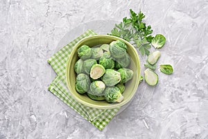 Bowl with fresh brussels sprouts on table, top view