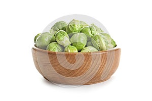 Bowl of fresh Brussels sprouts on white