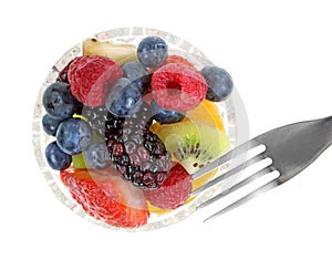 Bowl of fresh fruit with a fork