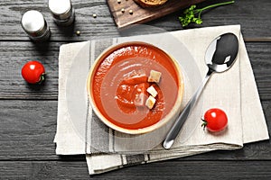 Bowl with fresh homemade tomato soup on table, top view