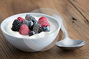 Bowl of fresh mixed berries and yogurt