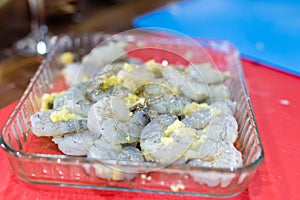 A bowl of fresh raw pacific white shrimp peeled with tail on.