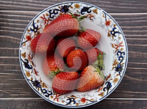 Bowl with fresh strawberries top view