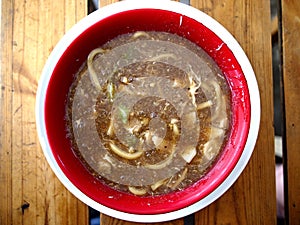 Bowl of freshly cooked fat egg noodles in thick soup