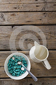 Bowl of froot loops and marshmallow with milk jug