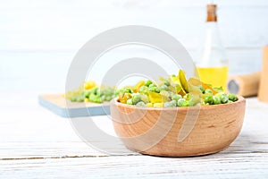 Bowl with frozen vegetable mix on table