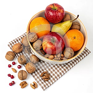 Bowl of fruit and nuts with a checkered background isolated