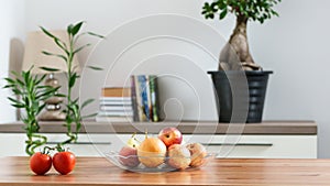 a bowl of fruit on a table in a home setting
