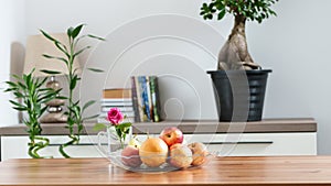 a bowl of fruit on a table in a home setting