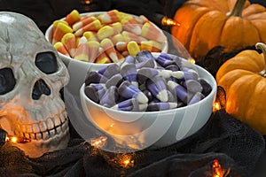 A bowl full of candy corn in a Halloween theme