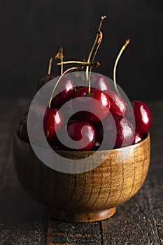 Bowl Full of Dark Red Cherries with Stems on a White Background