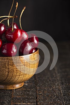 Bowl Full of Dark Red Cherries with Stems on a White Background