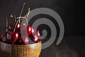 Bowl Full of Dark Red Cherries with Stems on a White Background