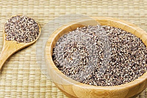 Bowl full of ground black pepper on a bamboo background
