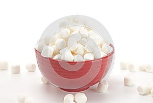 Bowl Full of Mini White Marshmallows on a White Background