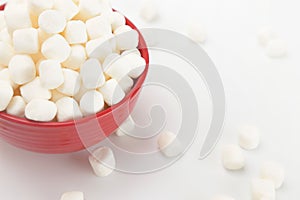 Bowl Full of Mini White Marshmallows on a White Background