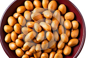 Bowl full of peanuts, some roasted and some still raw