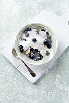 Bowl of granola with yogurt and bilberries. Concept for a tasty and healthy meal.