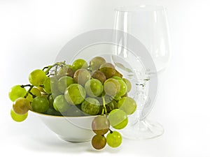 Bowl of grapes with a wine glass
