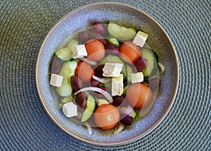 A bowl of Greek salad on the table