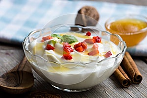 Bowl of greek yogurt with honey and strawberry