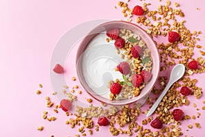 Bowl with greek yogurt, raspberries and granola. Top view flat lay. Healthy food, snack, breakfast