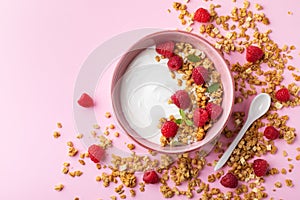 Bowl with greek yogurt, raspberries and granola. Top view flat lay. Healthy food, snack, breakfast photo