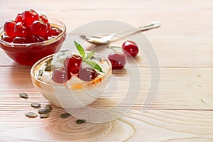 A bowl of greek yogurt with sugared cherry fruits, copy space.