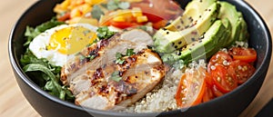 A Bowl of Grilled Chicken, Quinoa, Avocado, Tomatoes, and a Fried Egg