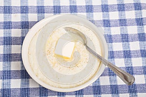 Bowl of Grits with Butter and Spoon