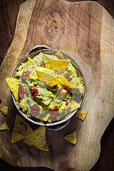 Bowl guacamole corn chips wooden table