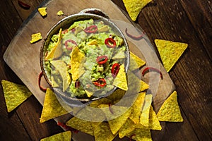 Bowl guacamole corn chips wooden table