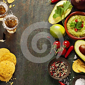 Bowl of guacamole with fresh ingredients and tequila shots