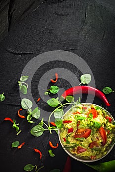bowl guacamole tomato chilli pepper lime onion garlic dill and oregano