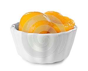 Bowl with halves of canned peaches